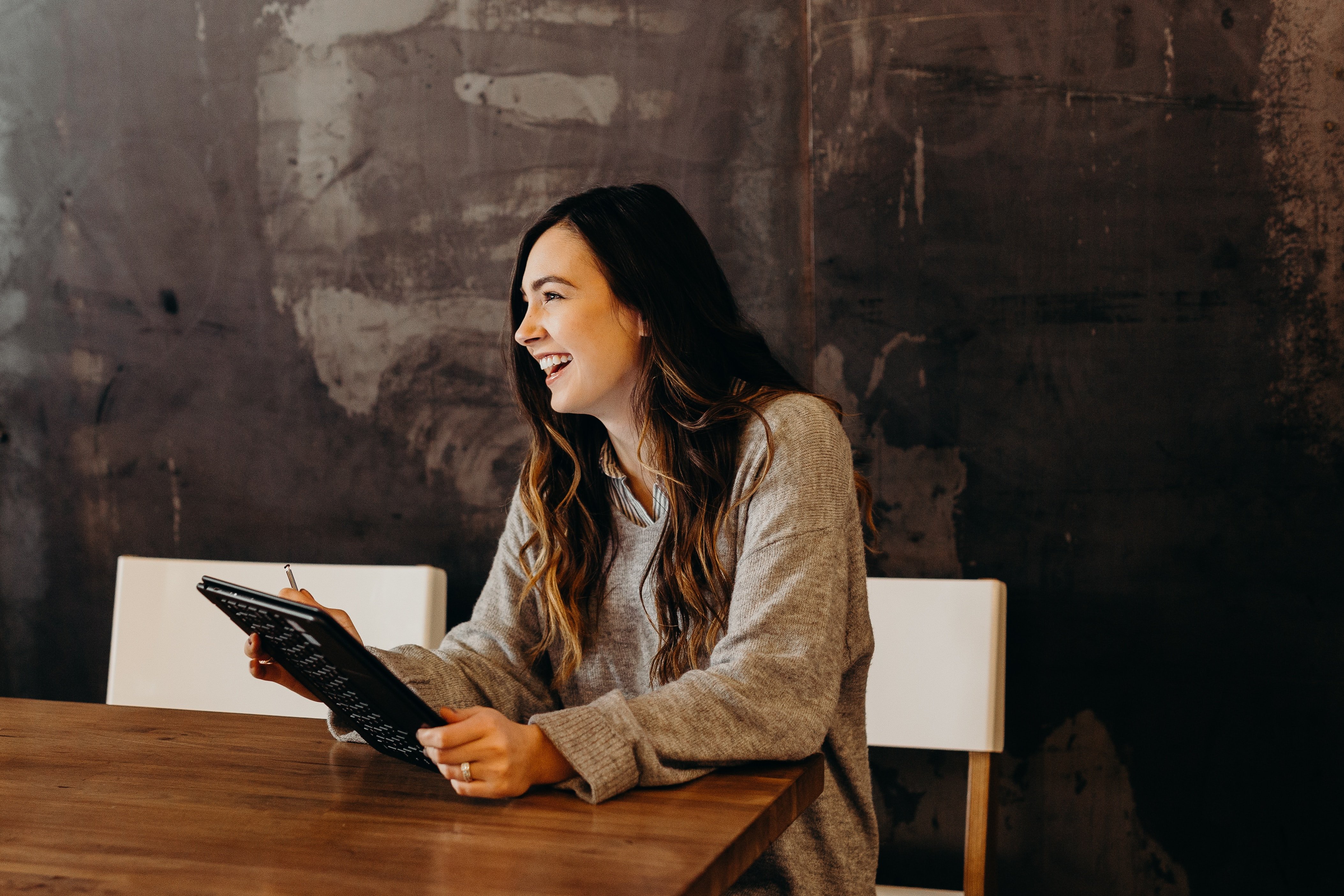 Smiling woman holding tablet